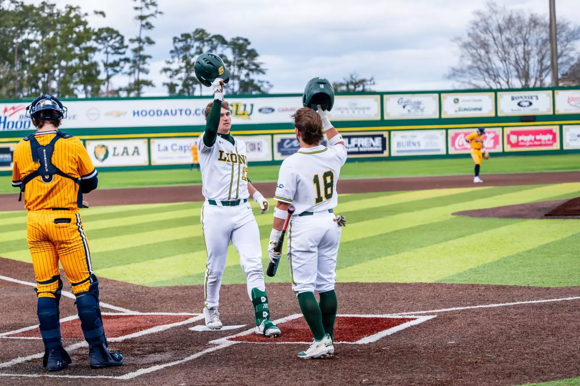 Dane Watts greets Brody Capps at home plate following the first home run of Capps' Lion career.