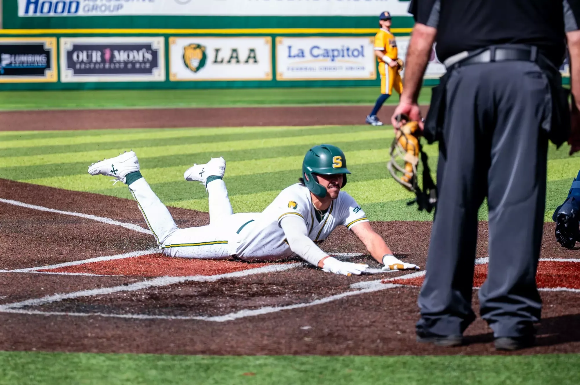 Lakin Polk slides into home plate.