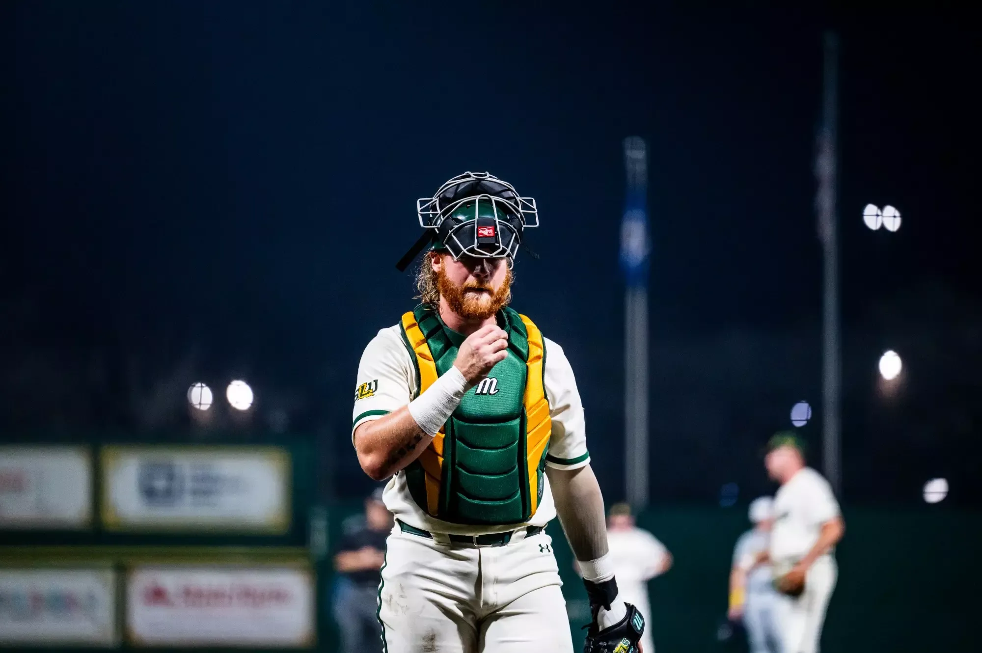 Blaise Priester walks back to the plate following a meeting on the mound.