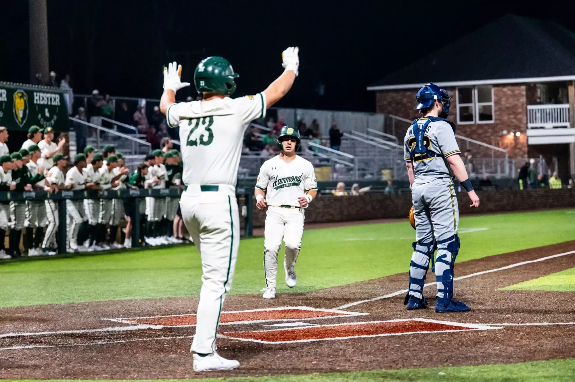 Peyton Woods waits for Ben Robichaux as he makes his way to the plate.