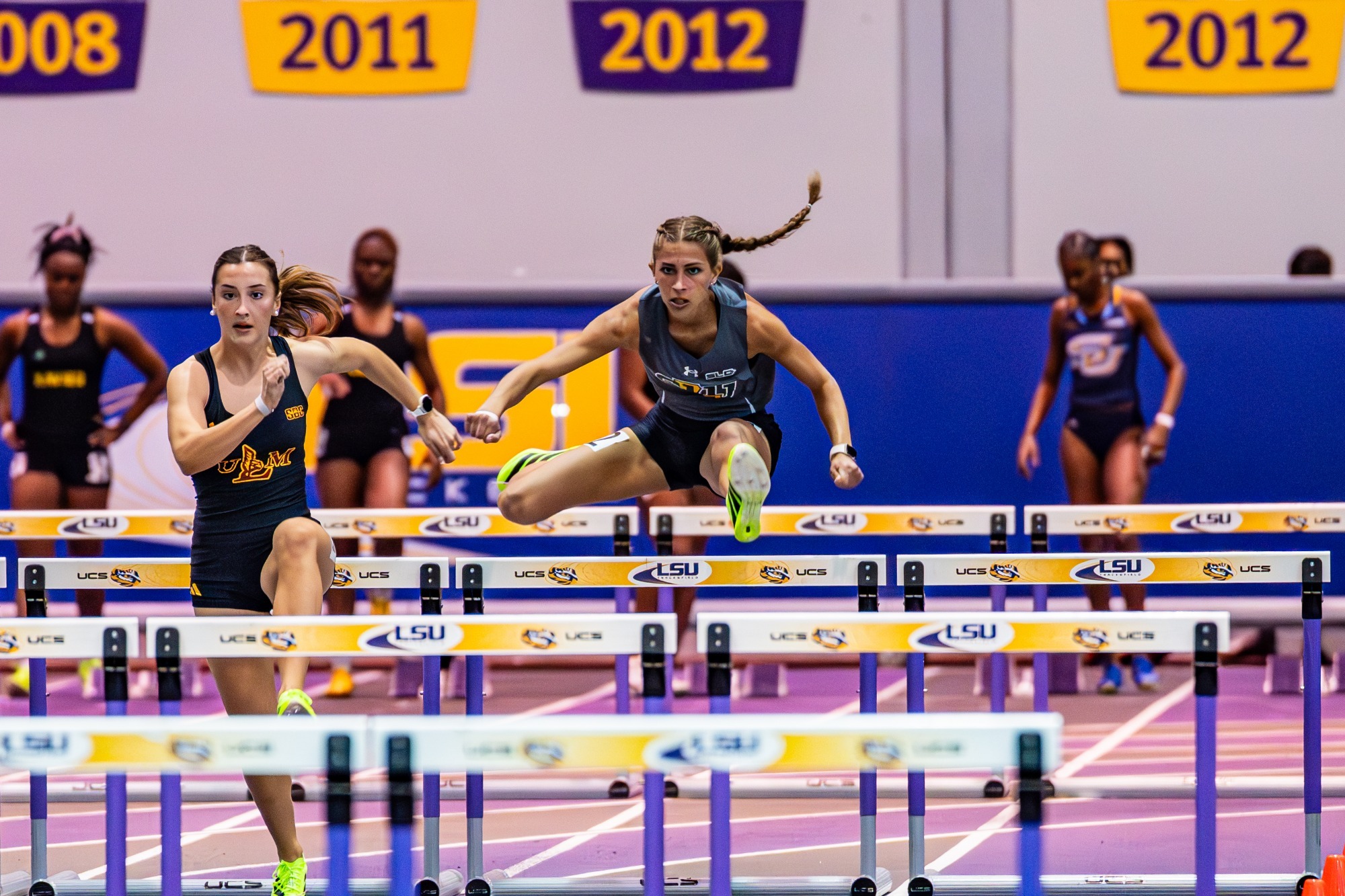 Emma Prieto hurdles at the LSU Purple Tiger meet