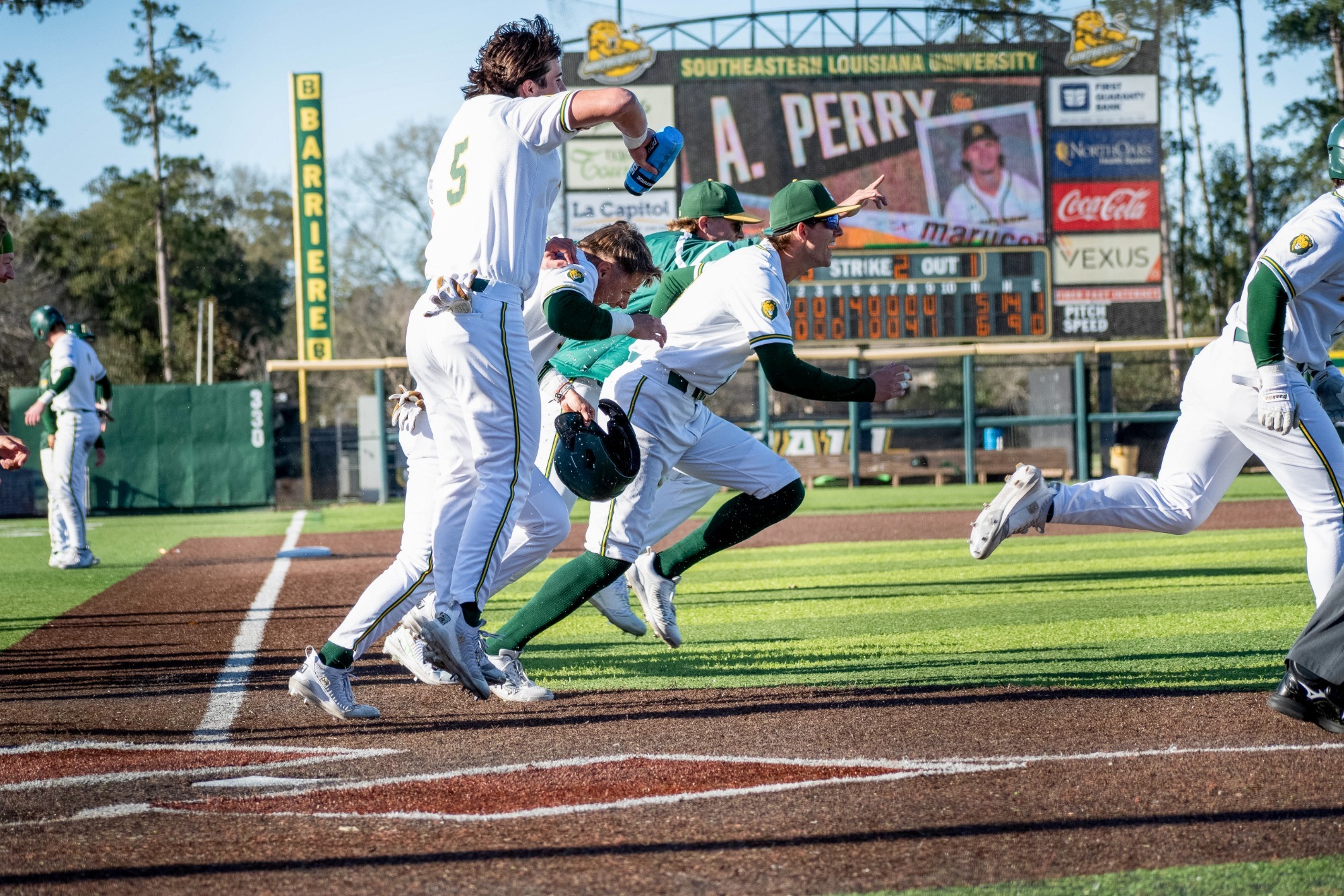 SLU baseball players storm the field after a walk-off win over Southern Illinois-Edwardsville.