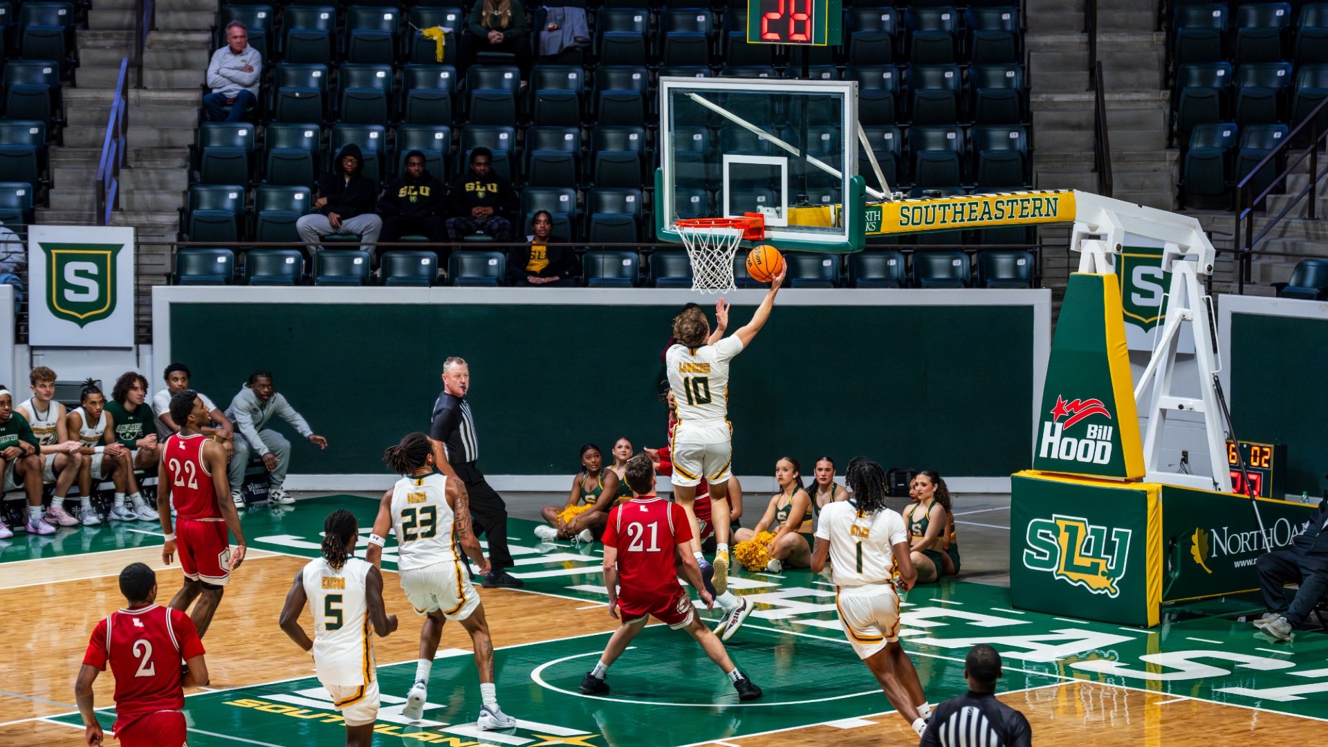Jaiden Lawrence driving to the rim for a layup against Nicholls defenders