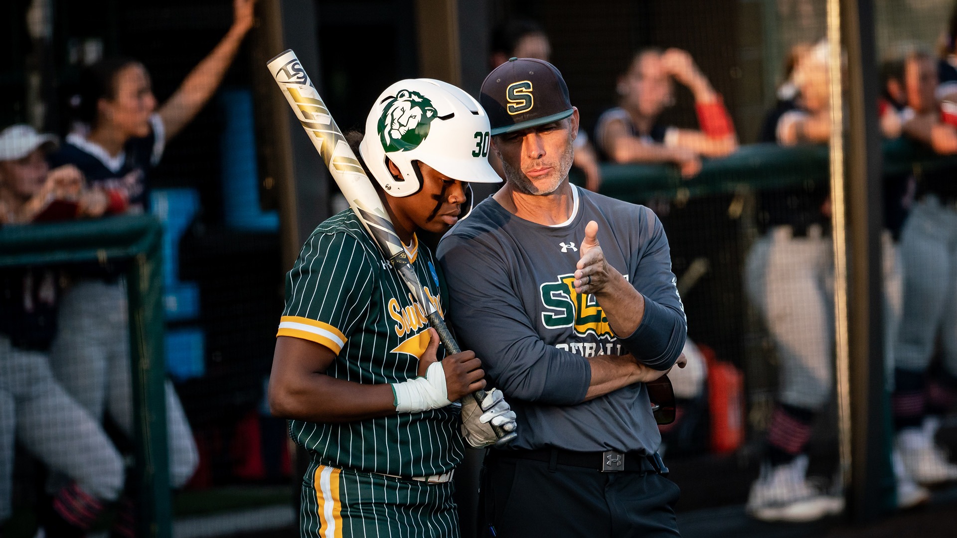 Ka'Lyn Watson and Head Coach Rick Fremin discuss strategy before an at-bat