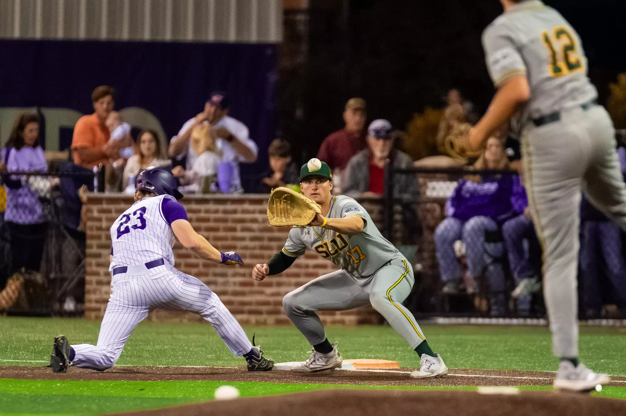 Brody Capps awaits a pickoff throw at first base.