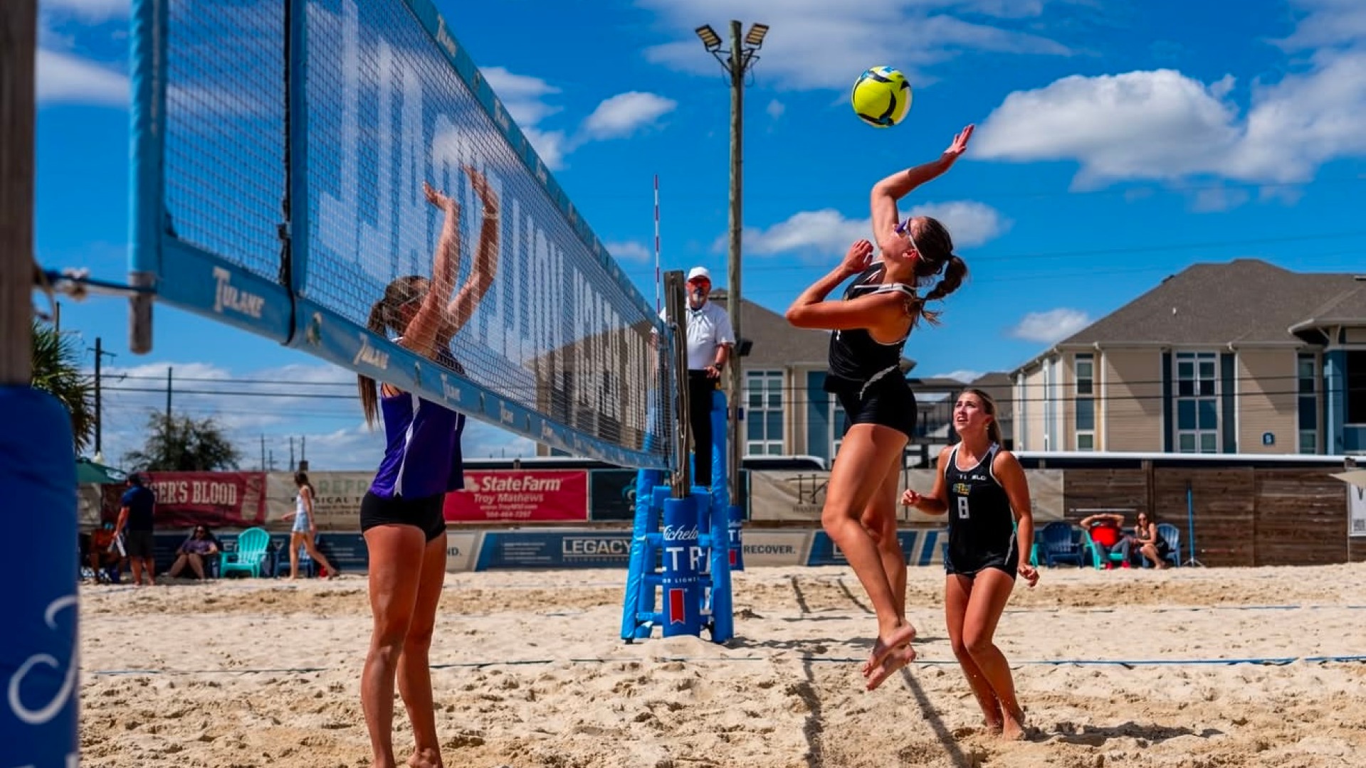Gabriella Hrubanova spiking it over the net alongside pair partner Mia Sauers vs Central Arkansas