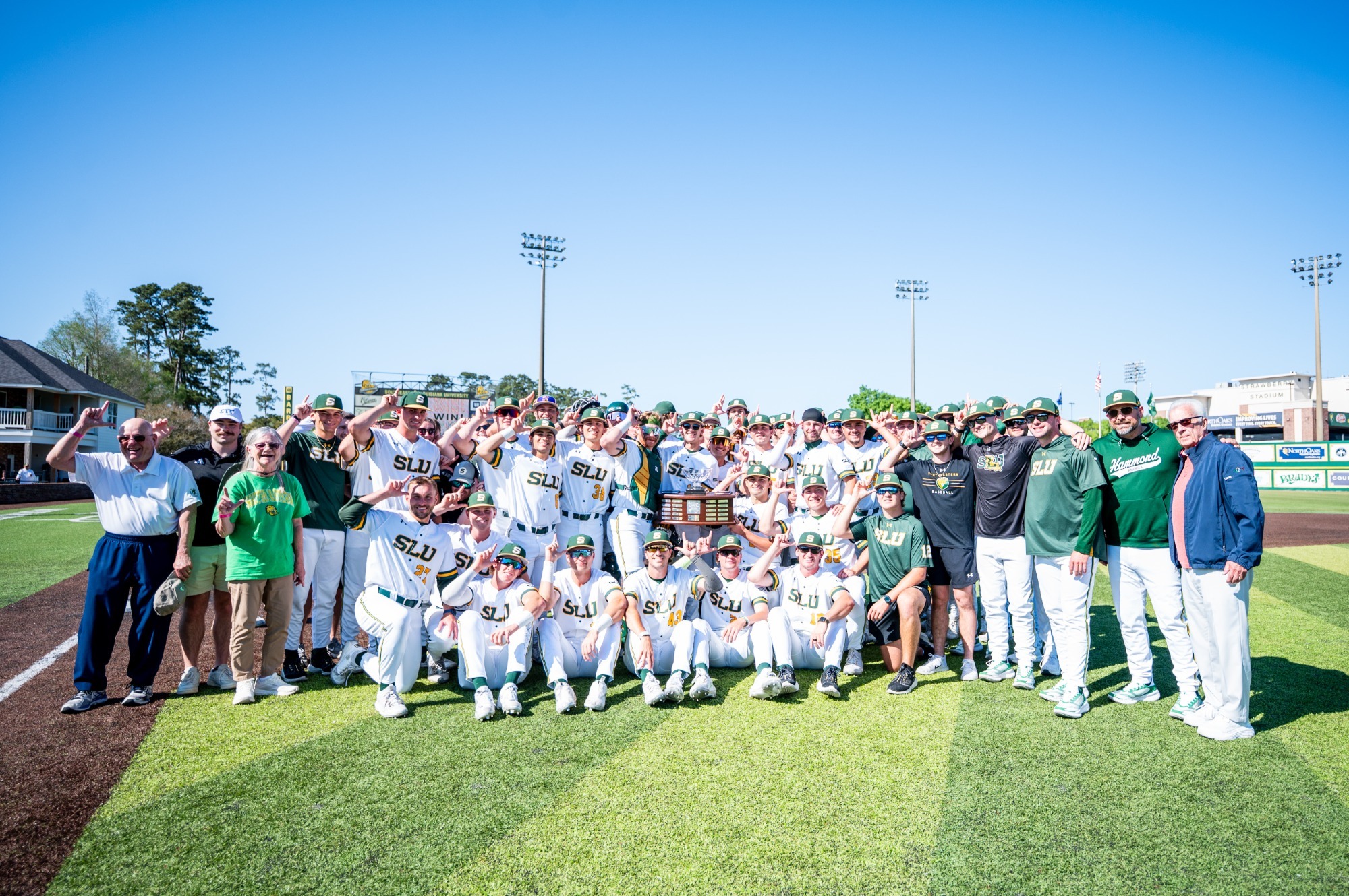 The 2026 SLU baseball team poses with the Pontchartrain Bowl trophy after taking the first two games of the rivalry series with New Orleans.