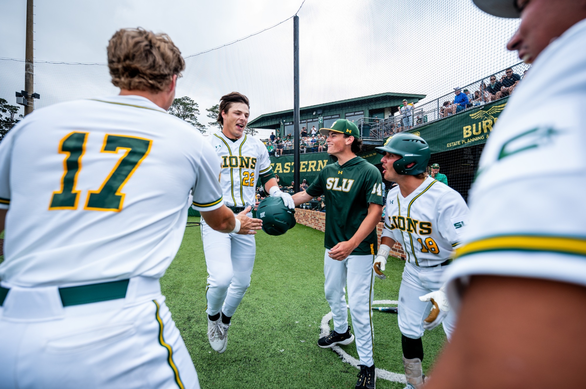 Rhett Centanni celebrates with his teammates as he returns to the dugout following the first home run of his SLU career.