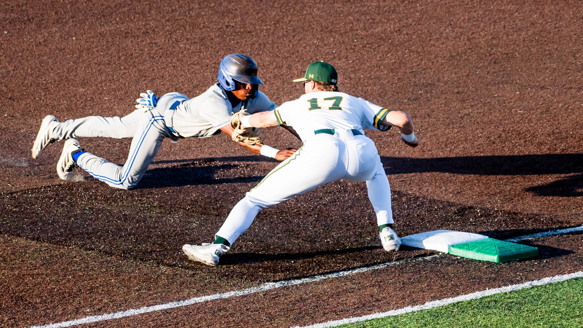 Brody Capps tags out an Islander runner on a pickoff attempt at first base.