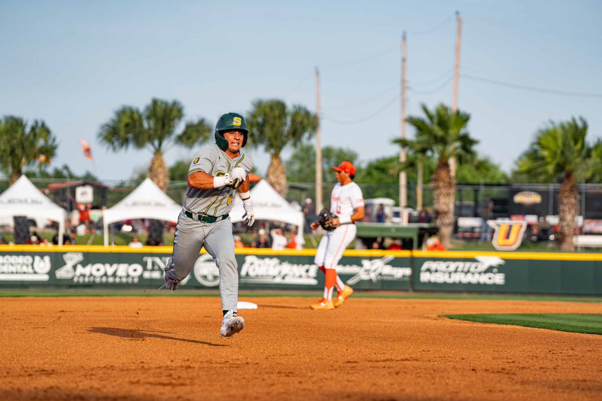 Ben Robichaux hustles to third base in front of a sold-out stadium in Edinburg, Texas.
