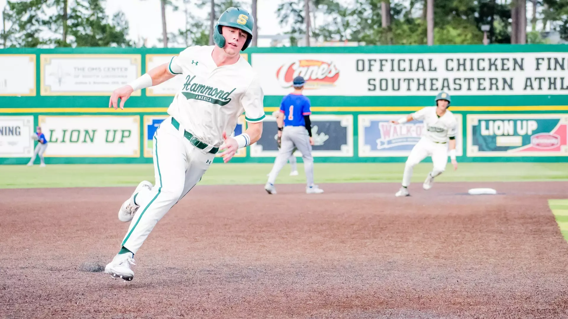 Connor Cuff round third base to head home as Brody Capps trails at second base on a base hit to right-center field.