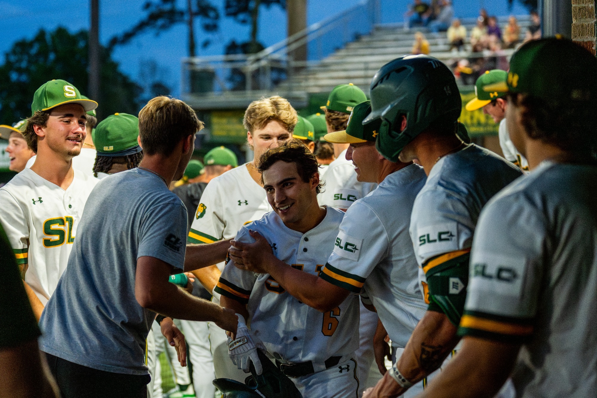 Ben Robichaux is greeted by his teammates after returning to the dugout following his seventh home run of the season.
