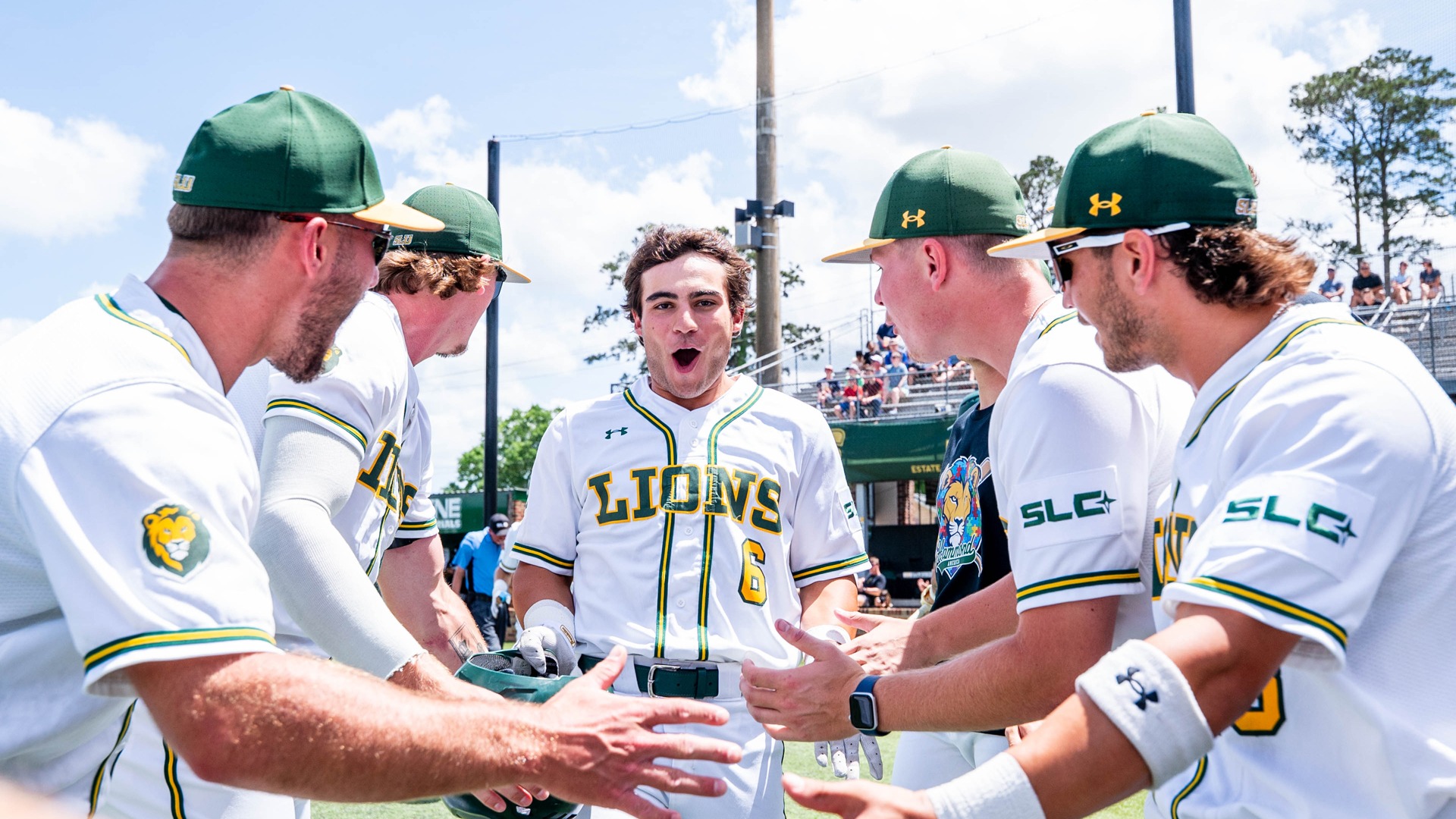 An exuberant Ben Robichaux is welcomed back to the dugout after hitting a home run.