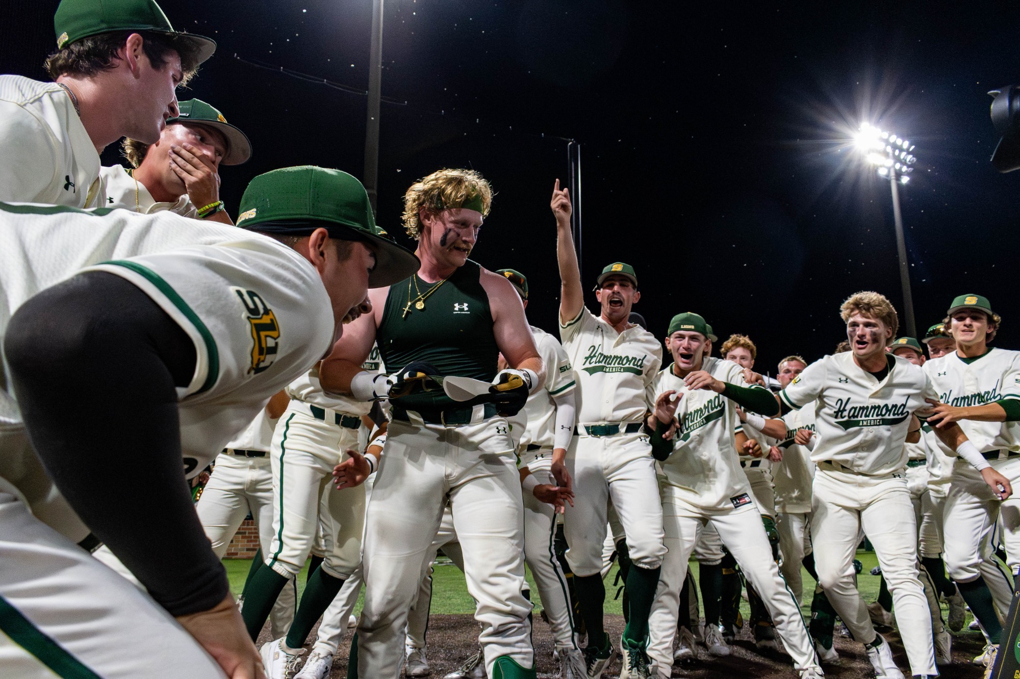 The Lion baseball team surrounds Blaise Priester as he crosses the plate after hittinga walk-off home run against HCU in the Southland Conference Tournament.