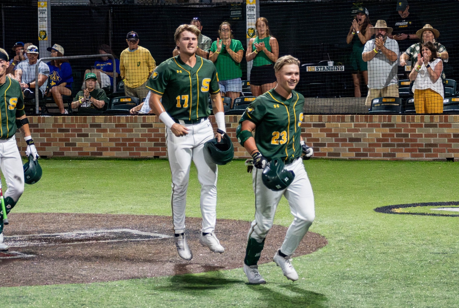 Peyton Woods and Brody Capps head back to the dugout after Woods' towering two-run homer in extra innings.