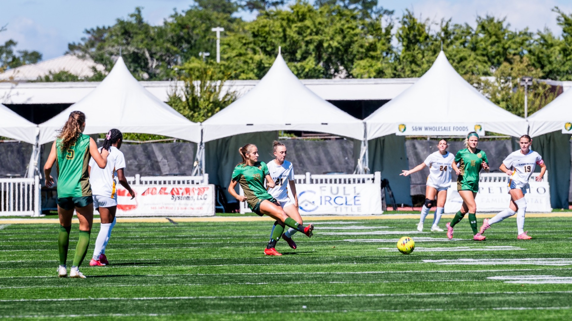 Southeastern soccer player Alex Knight gaining control of the ball against multiple East Texas A&M defenders
