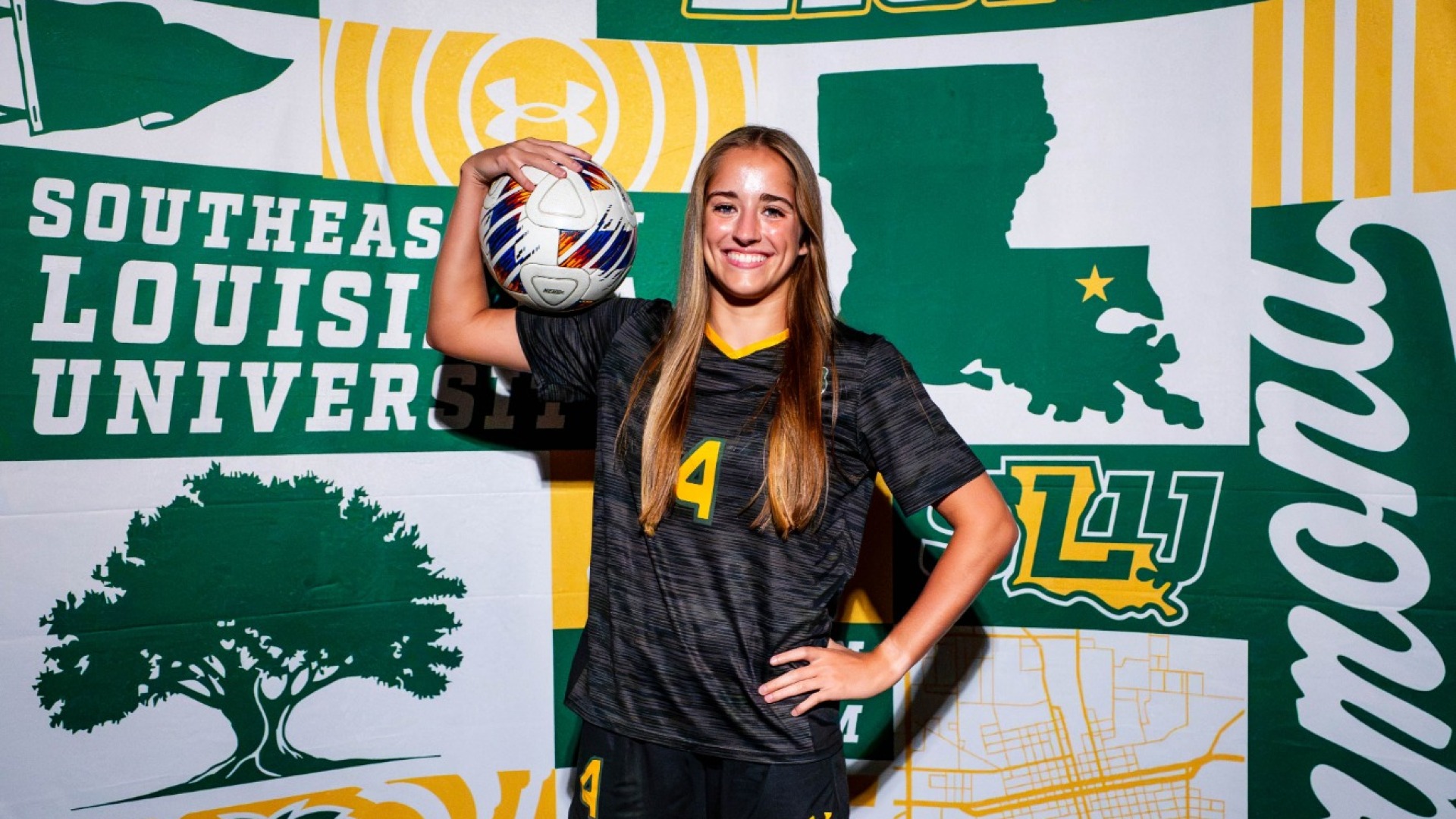 Women's soccer player Alex Knight posing with soccer ball for 2026 Media Day Picture with Southeastern/LionUp backdrop