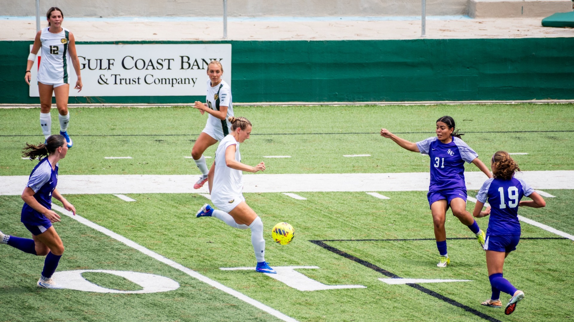 Brooke Opferman working to control the ball at Strawberry Stadium vs Spring Hill College defenders