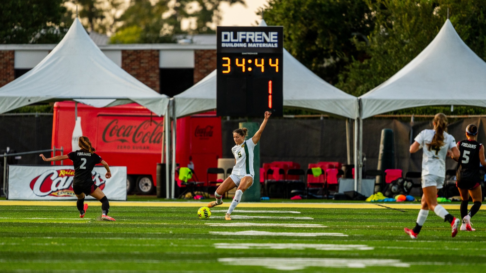 Women's soccer player Isabella Walls kicking the ball away from the net vs Spring Hill offensive attacks