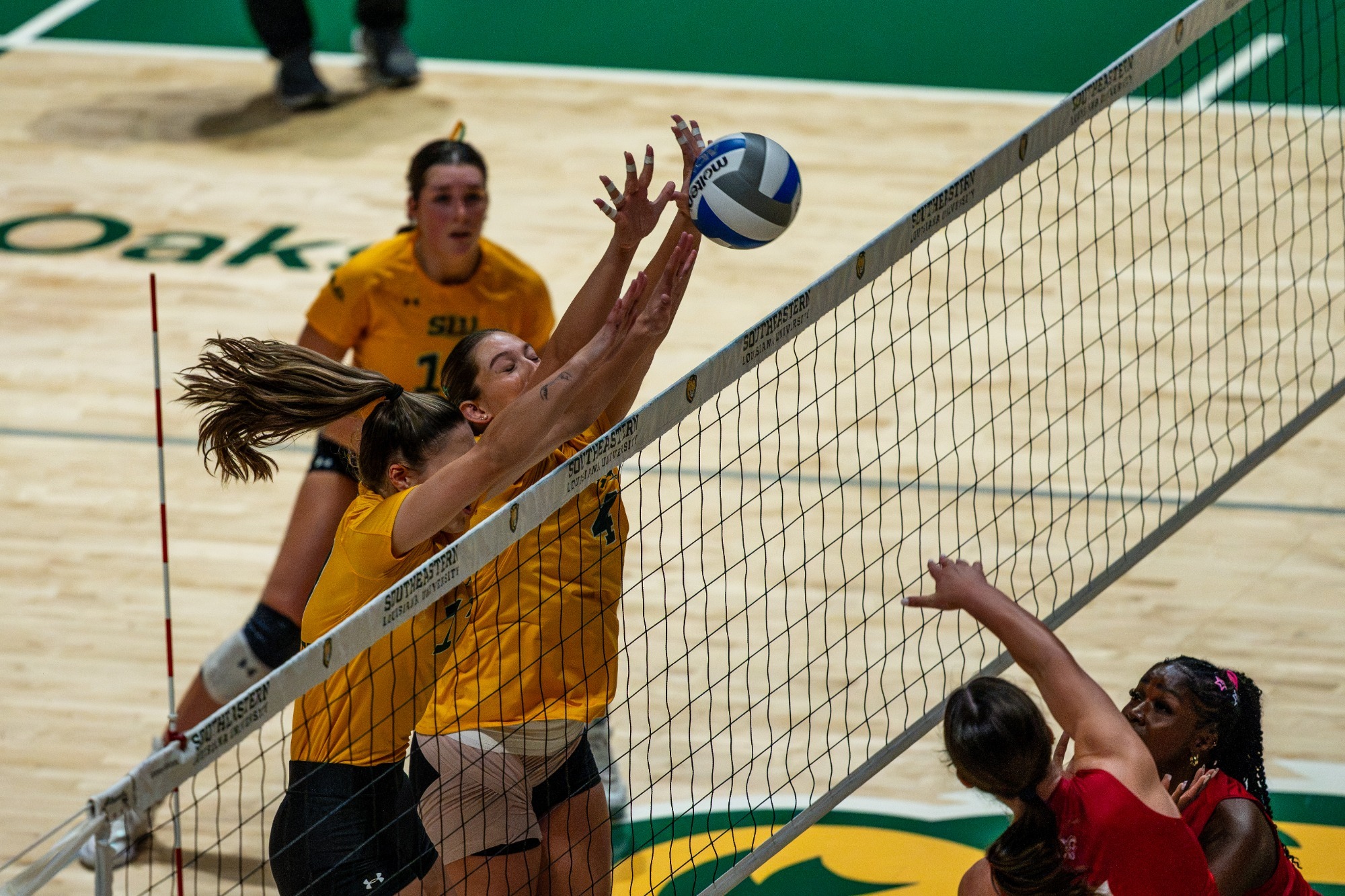 VB: Ainsley Driska and Kyra McKelvey go for a block in the University Center