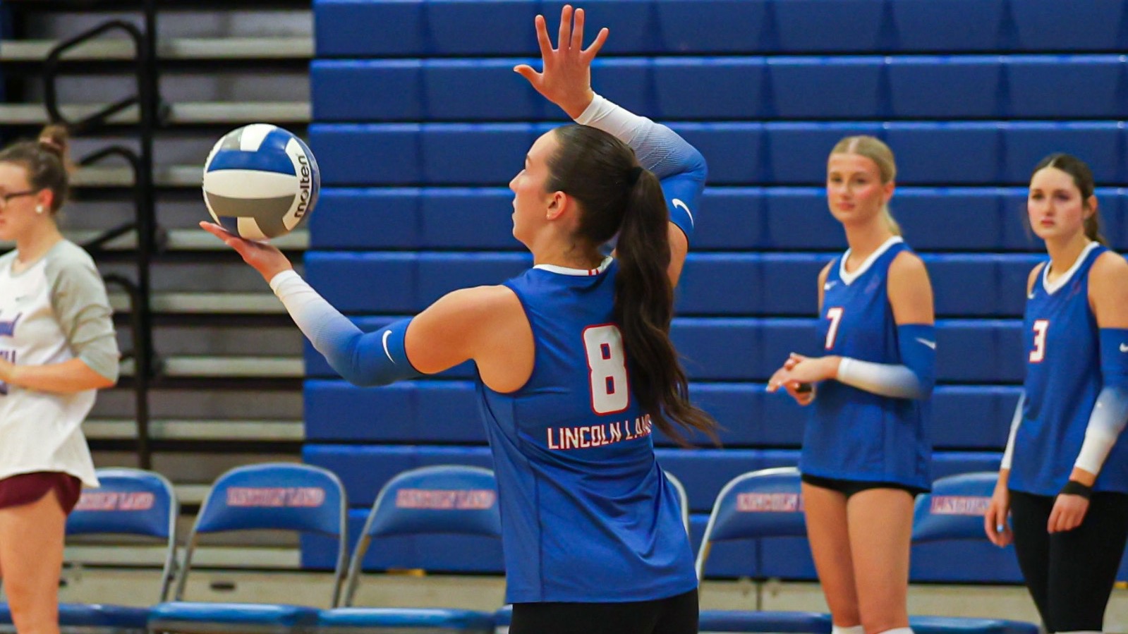 LLCC volleyball player hitting a volleyball.