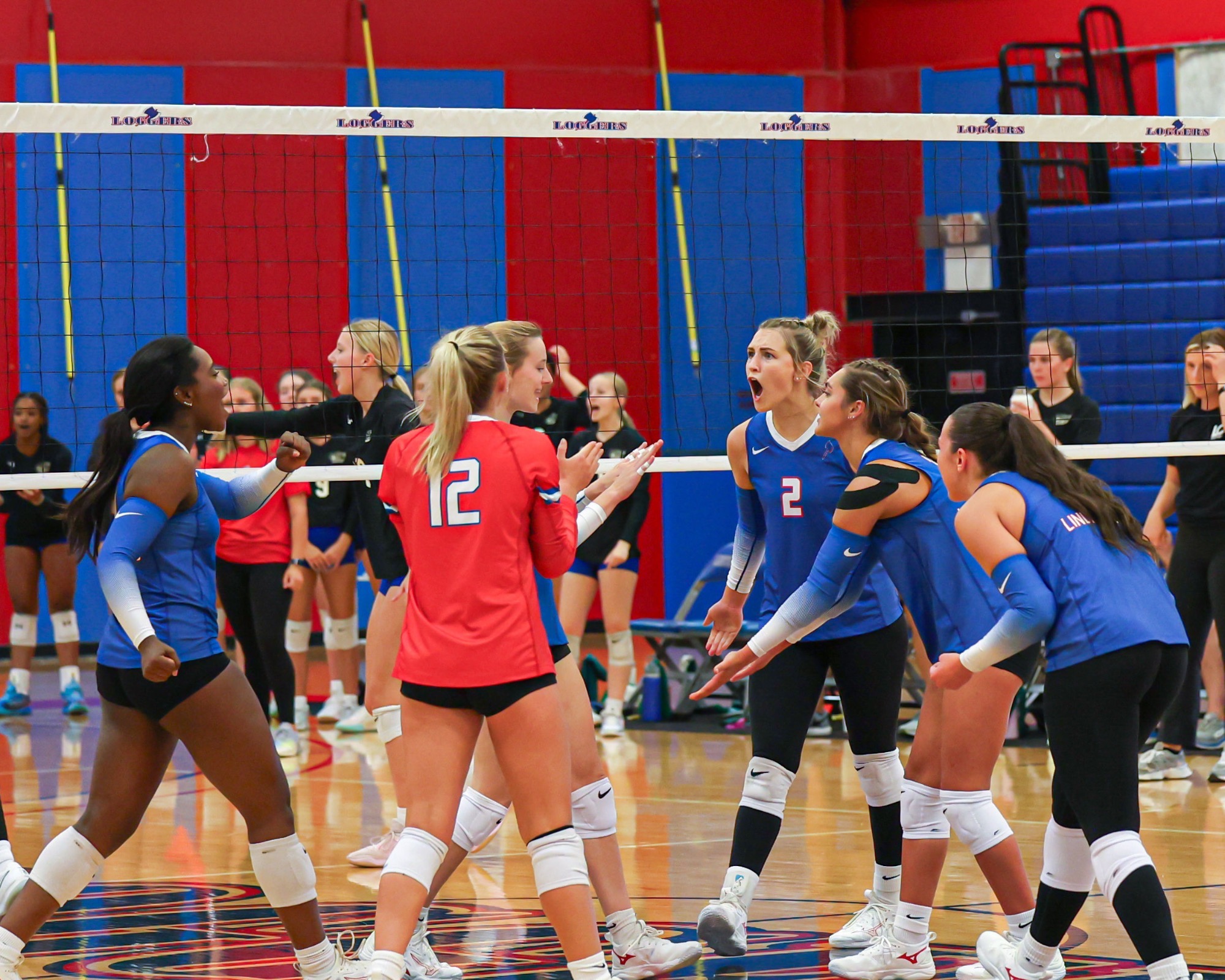 LLCC volleyball team cheering.