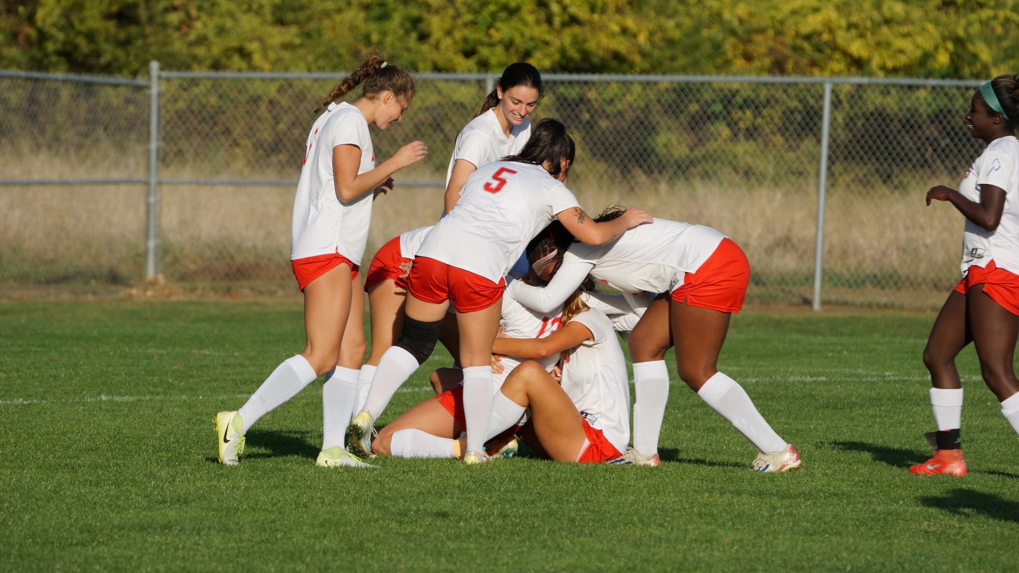 Girls cheering for soccer.