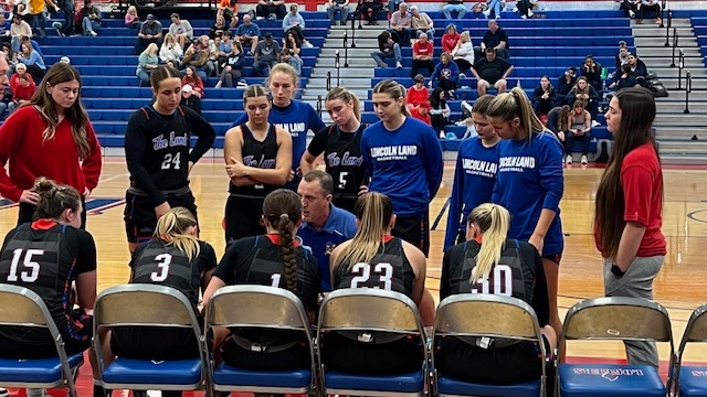 LLCC women's basketball team sitting.