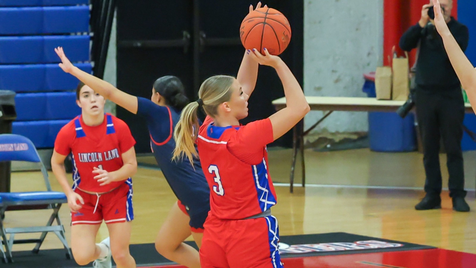 LLCC women's basketball player shooting a basketball.