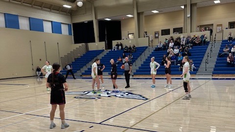 LLCC women's basketball playing basketball.