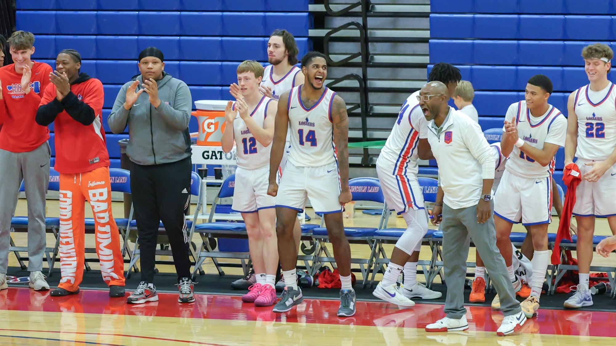 LLCC men's basketball team cheering.