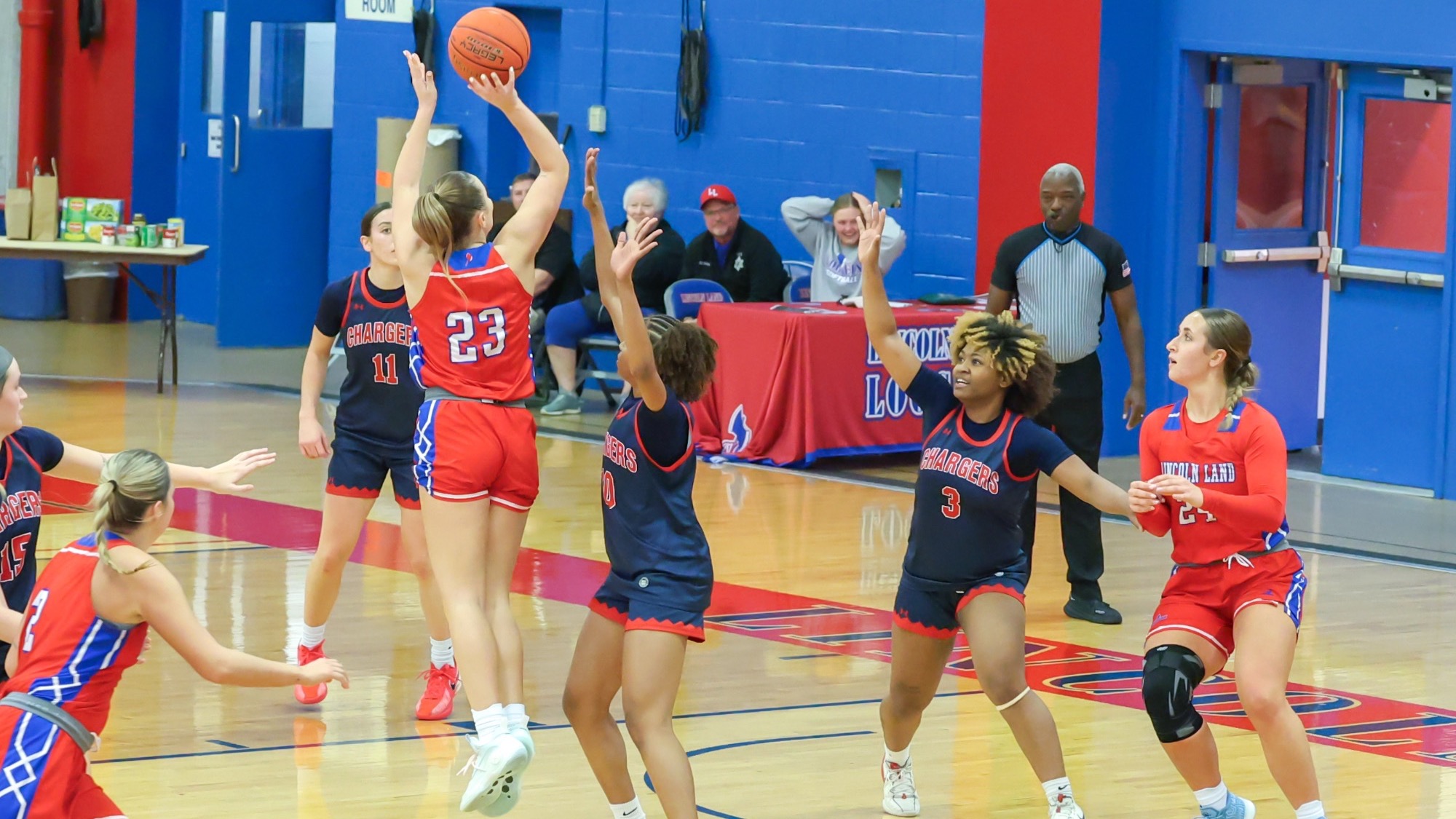 LLCC women's basketball team playing basketball.