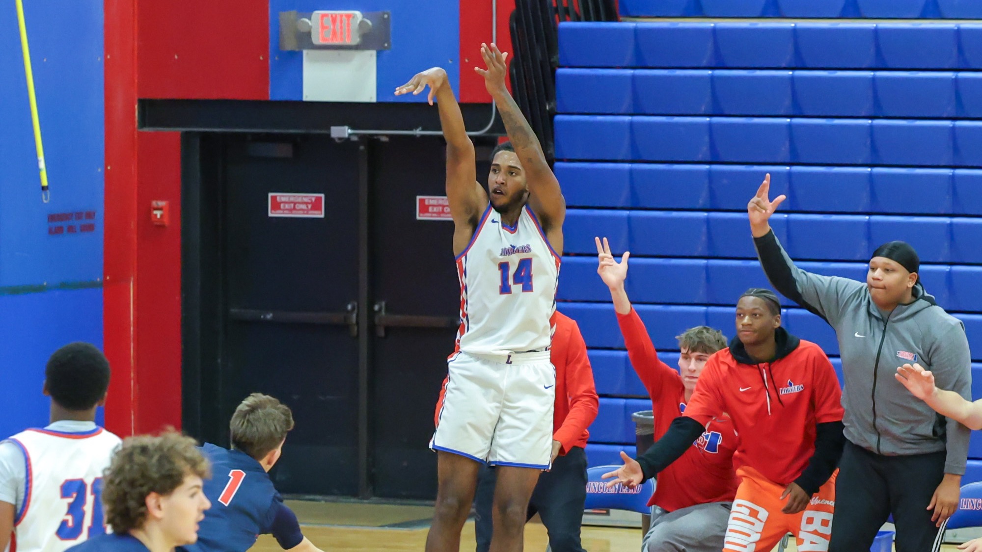 LLCC men's basketball team playing basketball.