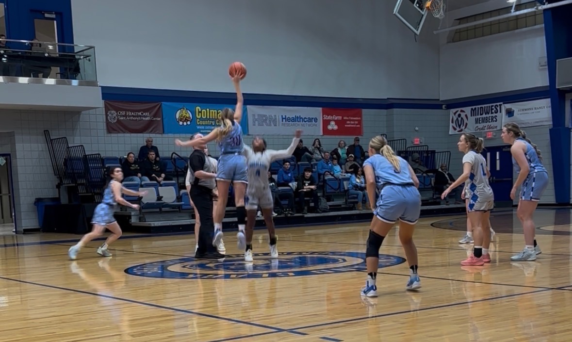 LLCC women's basketball players playing basketball.