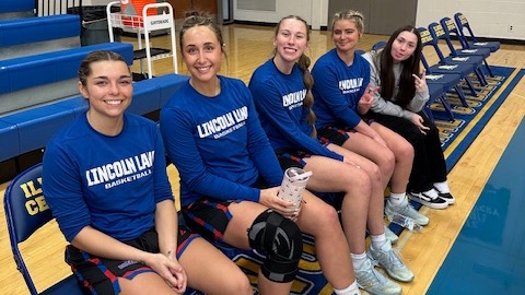 LLCC women's basketball team sitting.