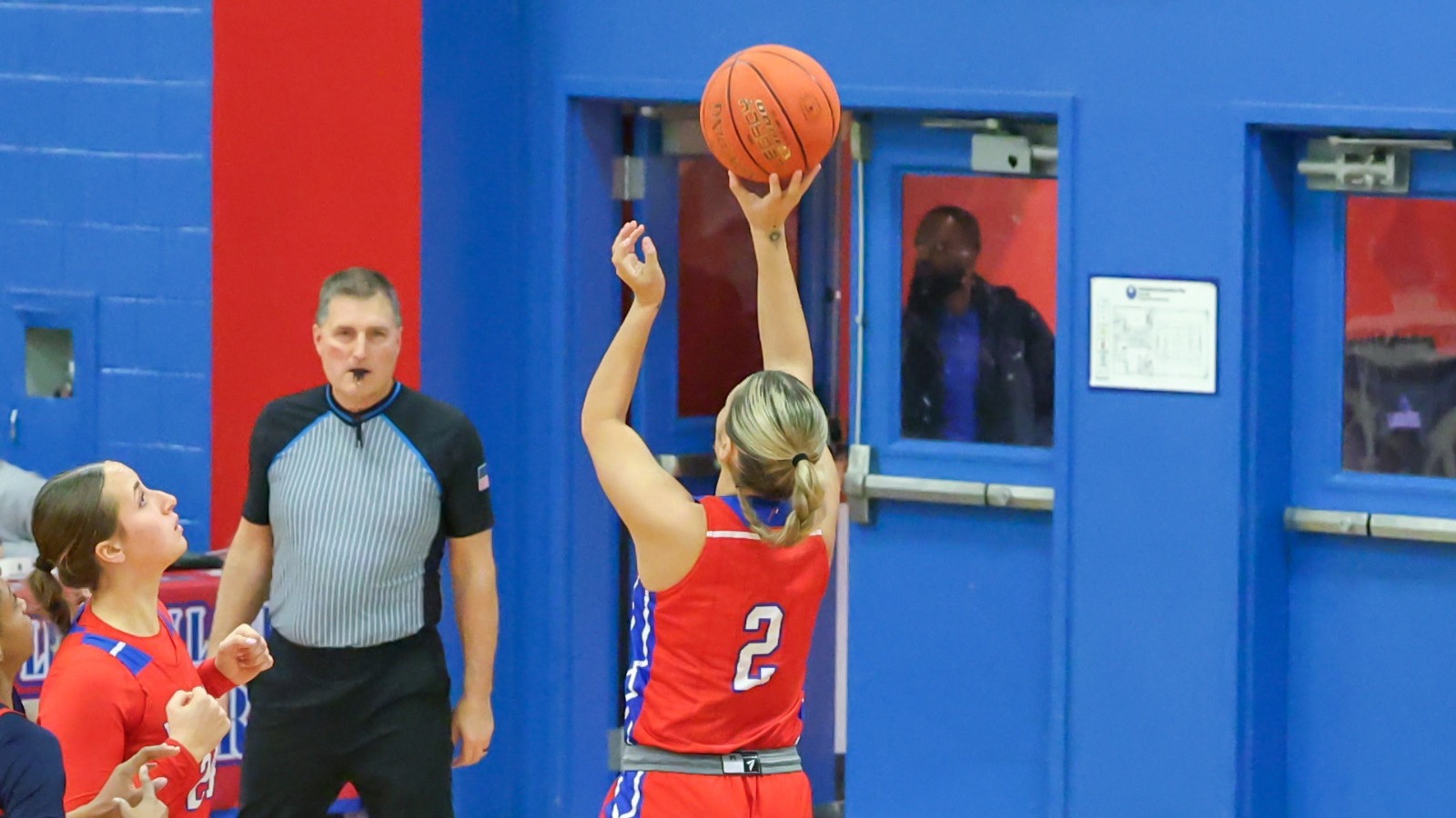 LLCC women's basketball player shooting a basketball.