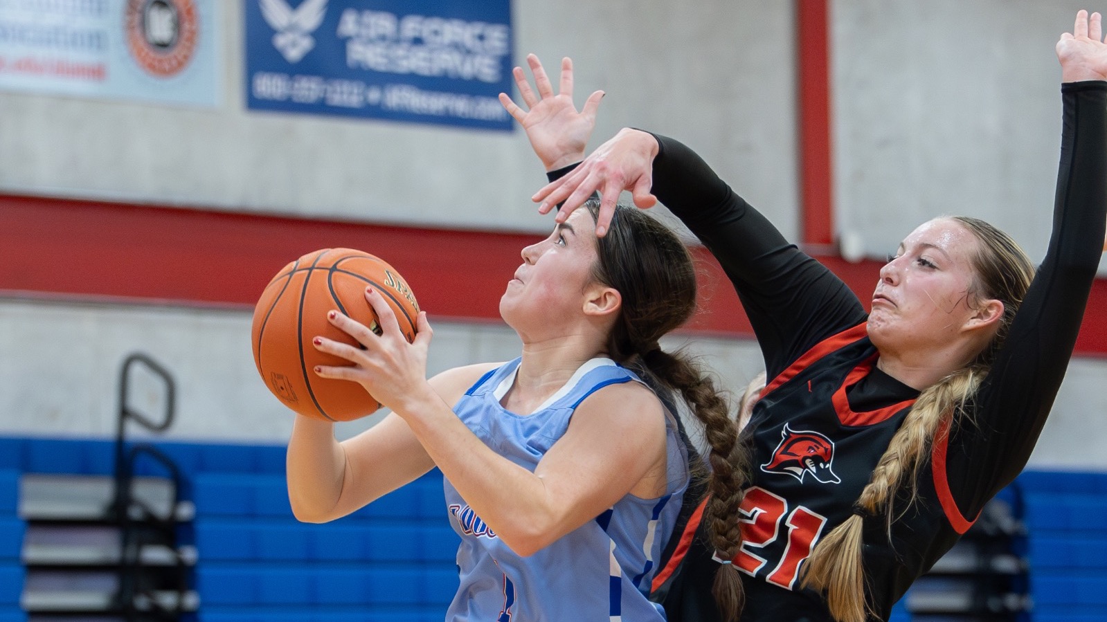 LLCC women's basketball player shooting a basketball.