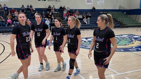 LLCC women's basketball team standing around.