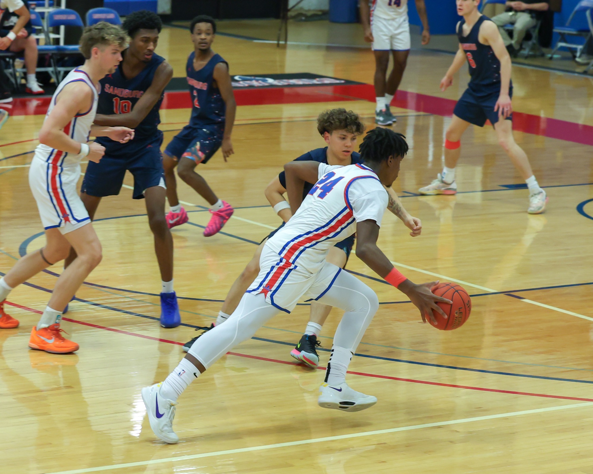 LLCC mens' basketball team playing basketball.