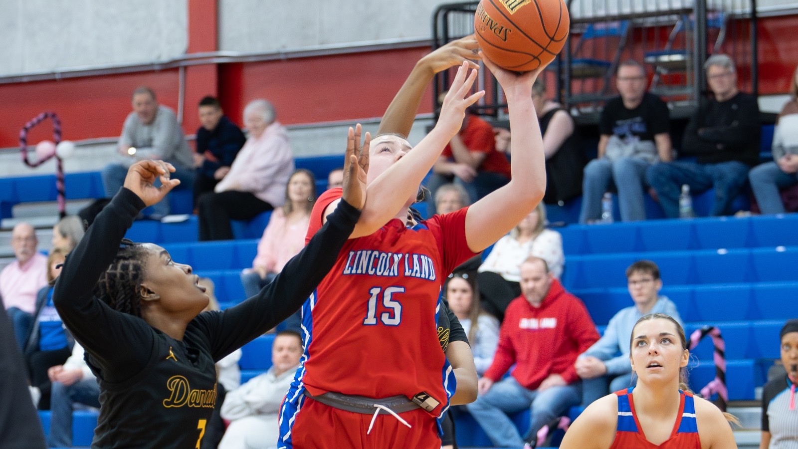 LLCC women's basketball team playing basketball.