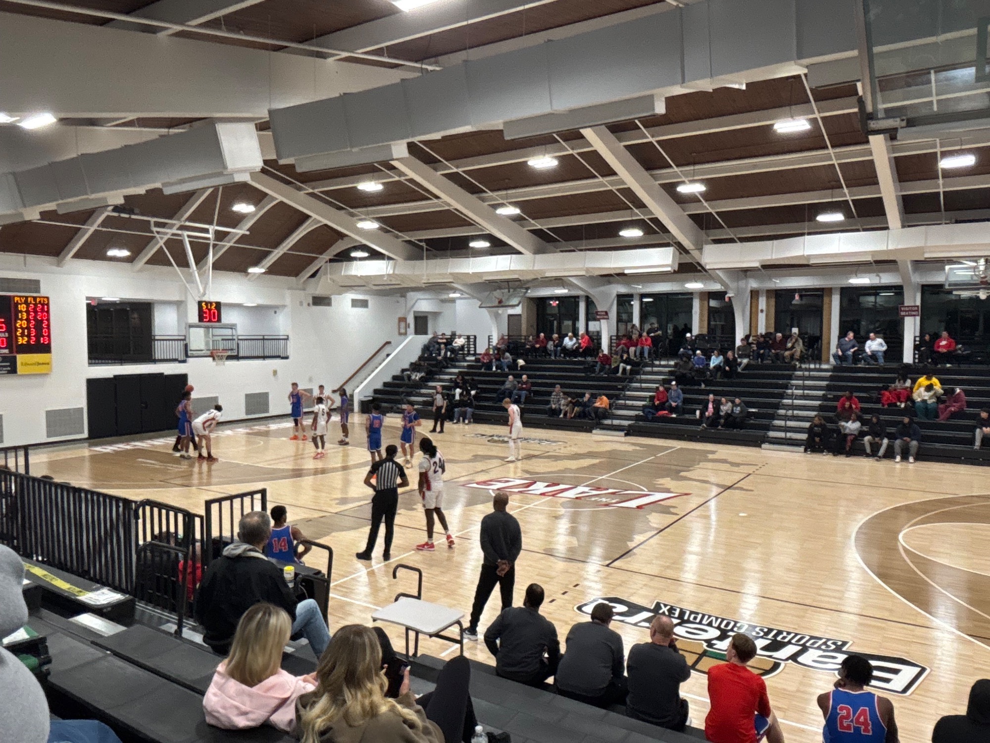 LLCC mens basketball team playing basketball.