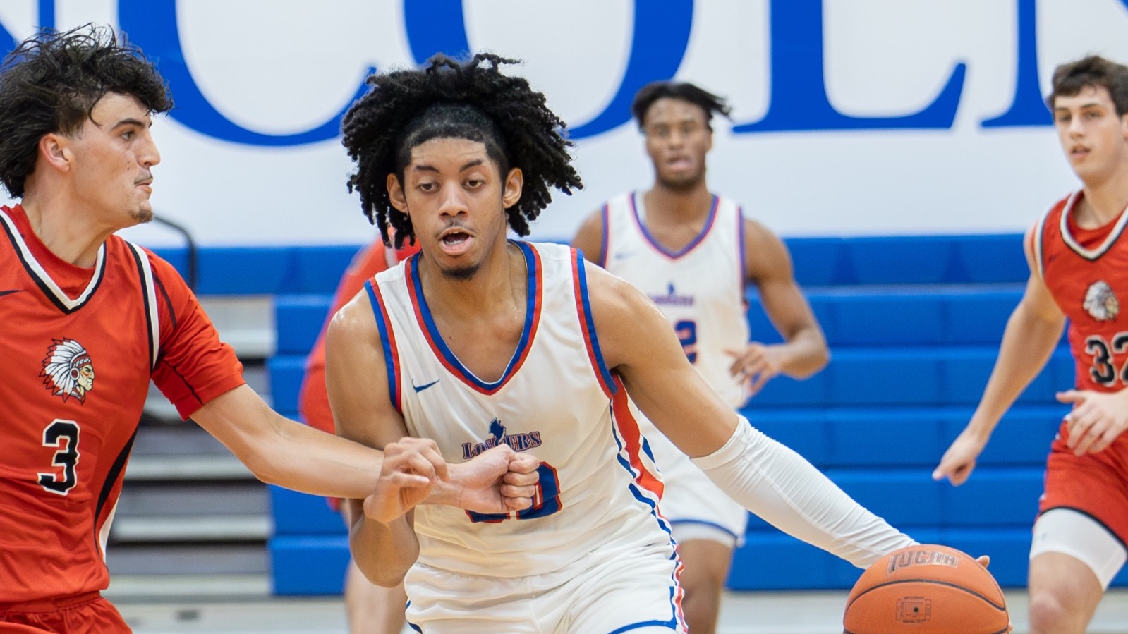 LLCC men's basketball player playing basketball.