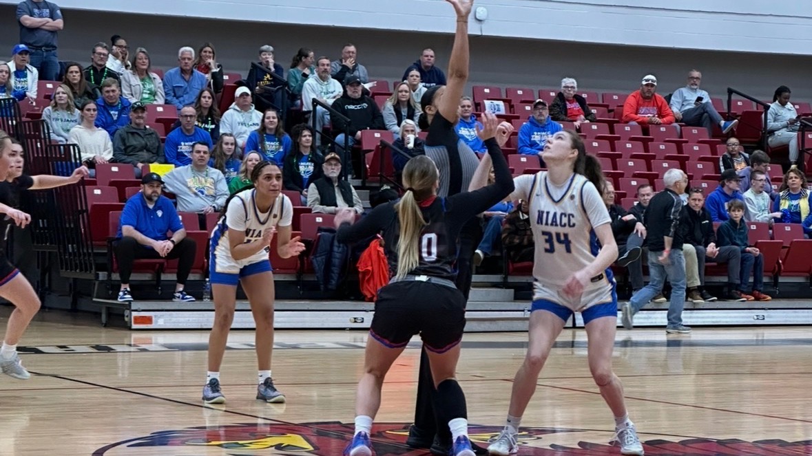 LLCC women's basketball playing basketball at the national tournament.