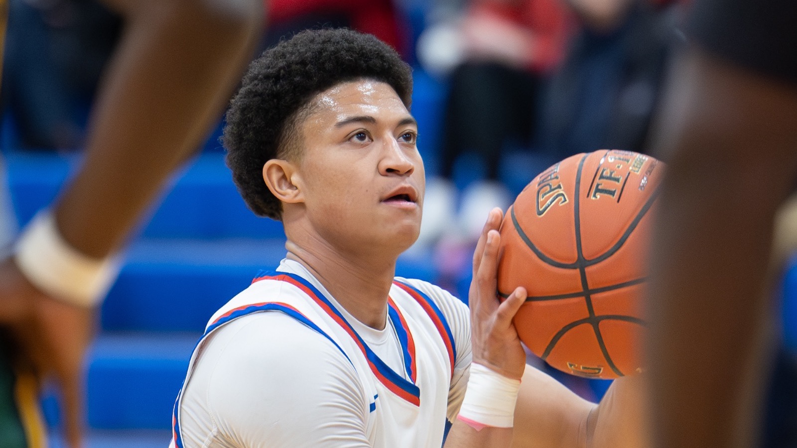LLCC basketball player shooting a basketball.