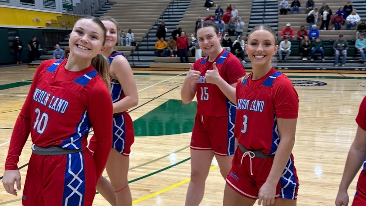 LLCC women's basketball team smiling.