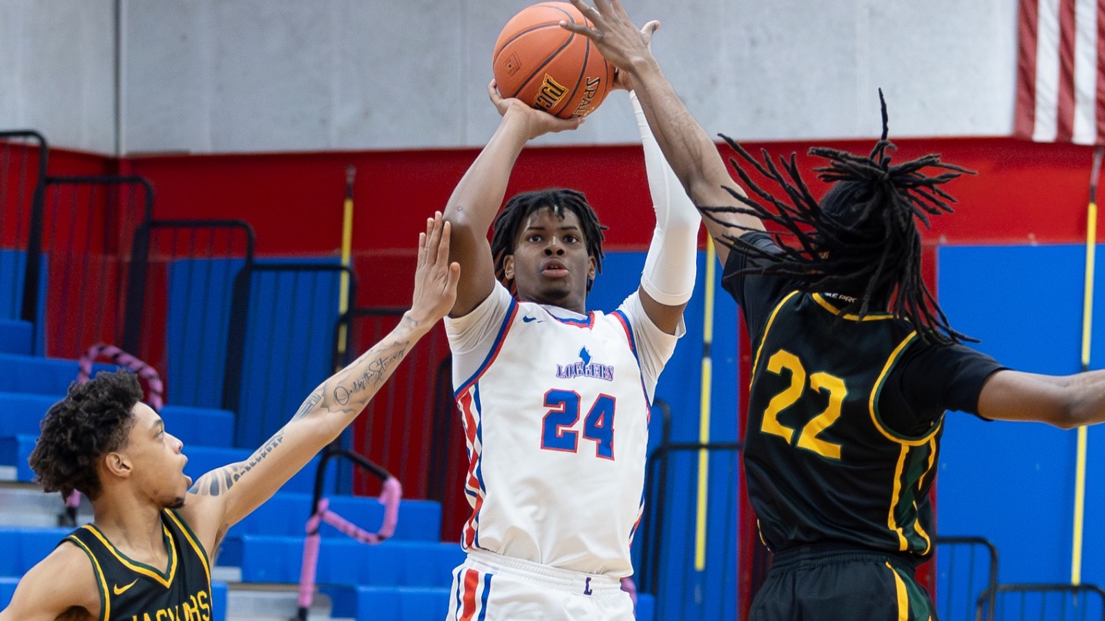 LLCC men's basketball player shooting a ball.