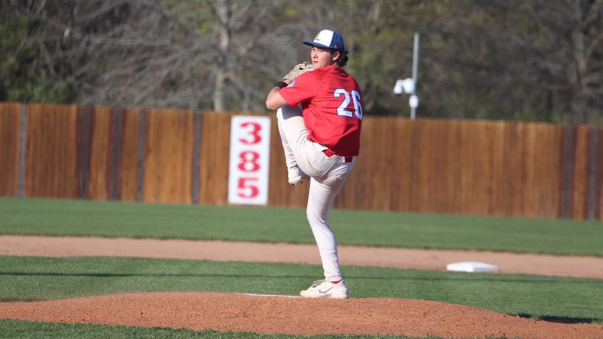 LLCC baseball player pitching.