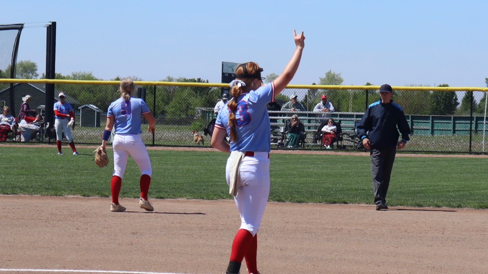 LLCC softball player holding up numbers.