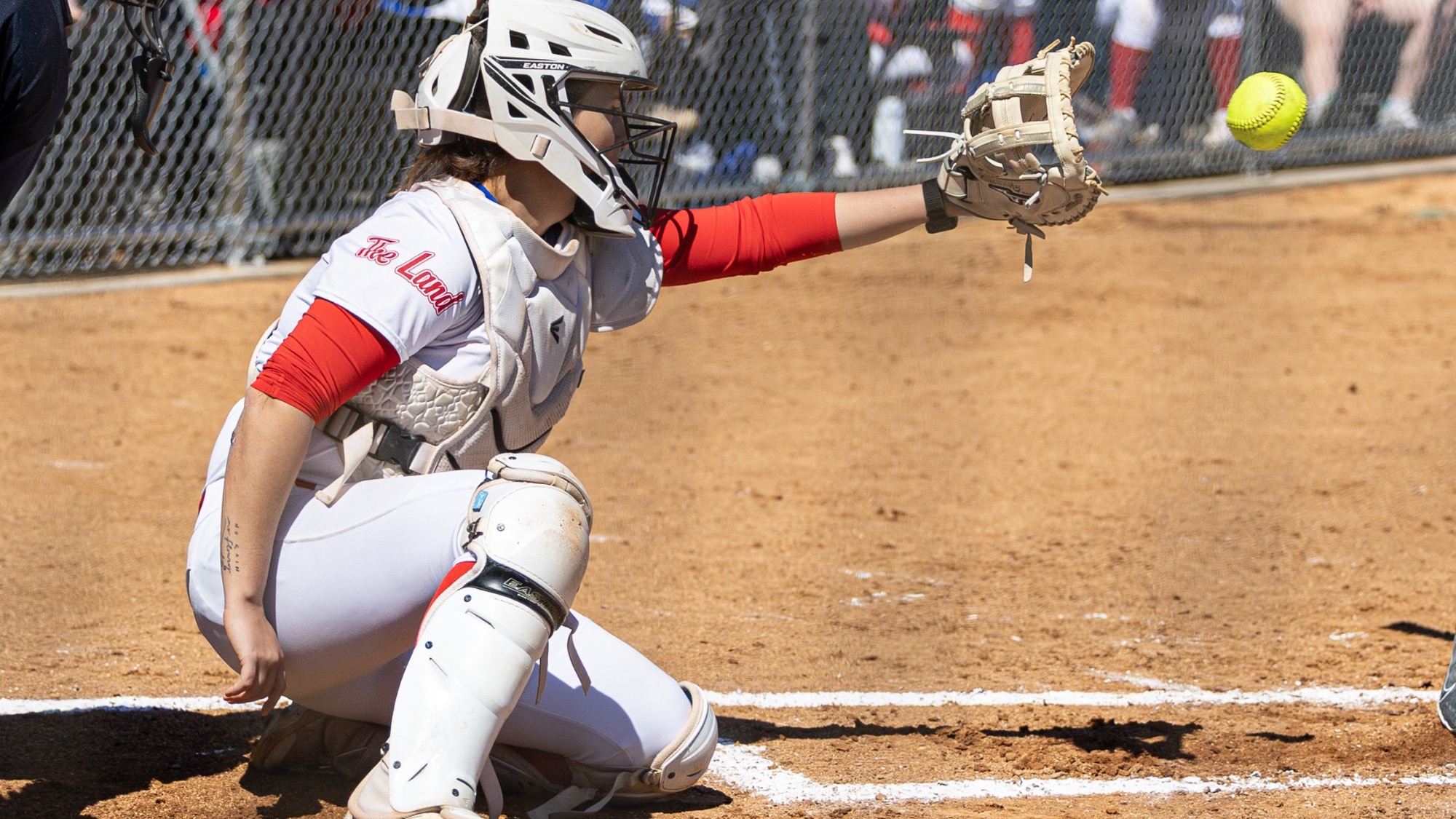 LLCC softball player catching a ball.