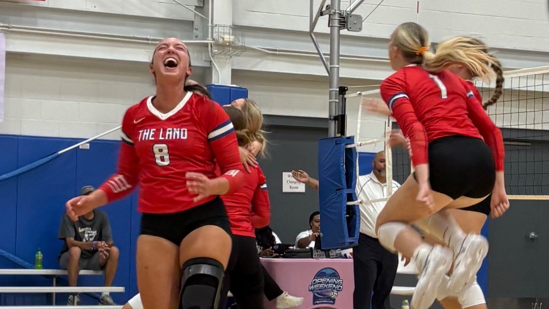 LLCC women's volleyball team cheering.